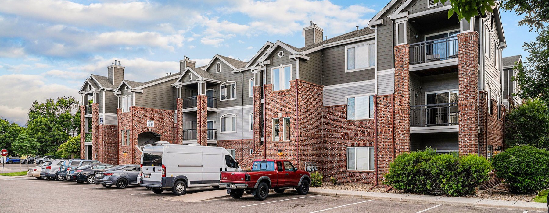 a red truck parked in front of a brick building