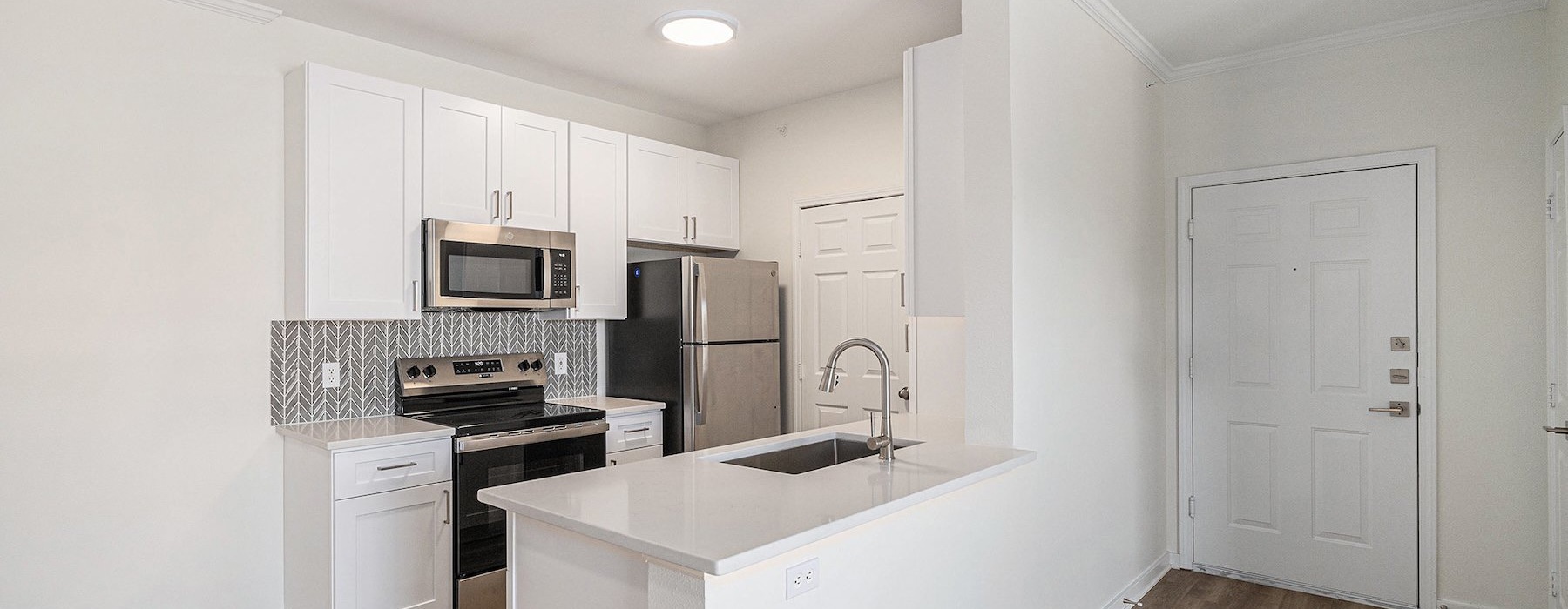 a kitchen with white cabinets