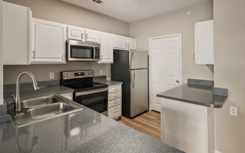 a kitchen with white cabinets