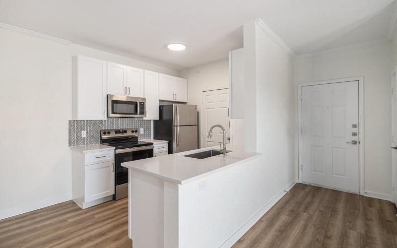 a kitchen with white cabinets