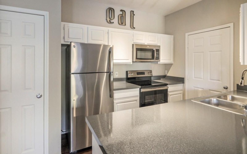 a kitchen with white cabinets